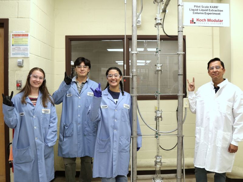 Assistant Professor of Instruction and students in front of new KARR@ Column, donated by Koch Modular.