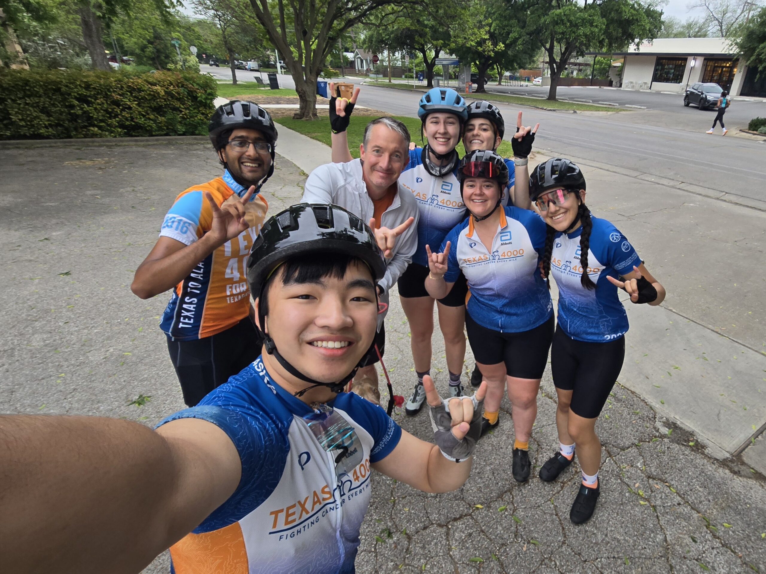 Texas 4000 Rockies riders take selfie with UT president.