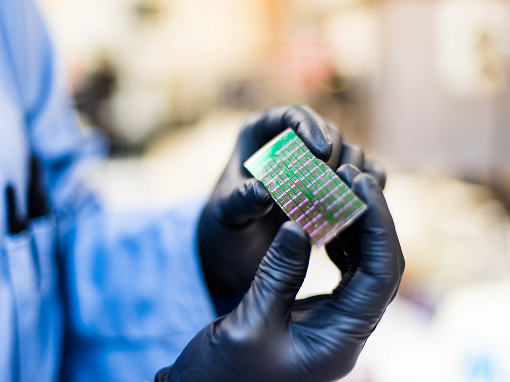 close up of circuit board held by hand