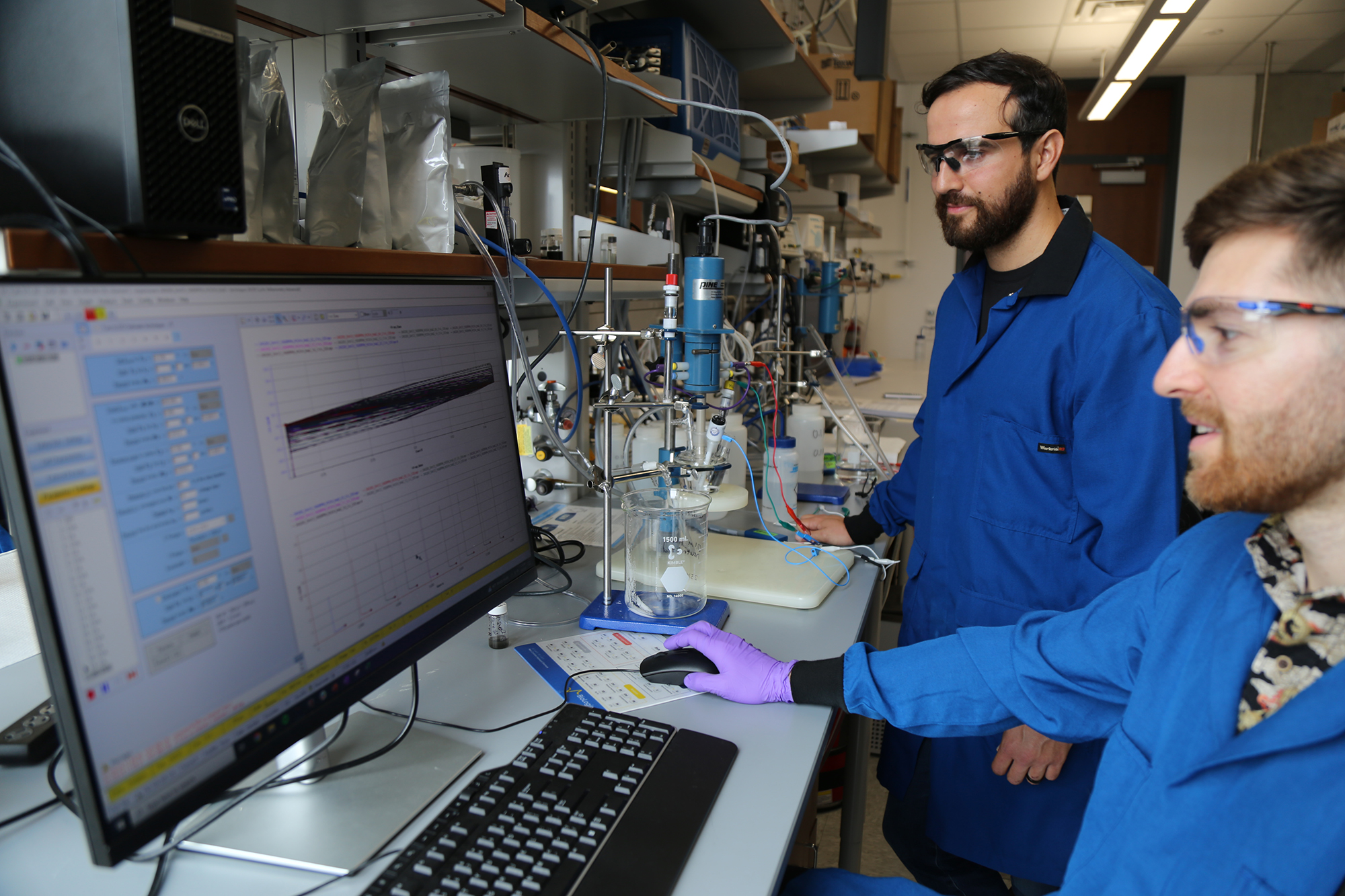 Texas Engineer Joaquin Resasco working in lab with researcher