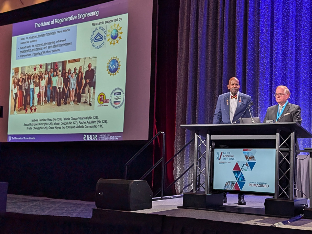 Texas Engineer Nicholas Peppas standing onstage with Dr. Sir Cato T. Laurencin