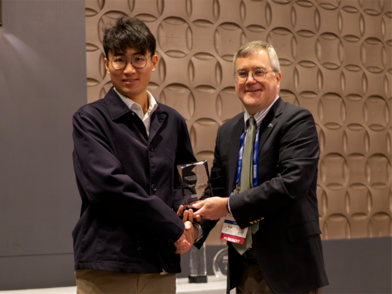 Texas Chemical Engineer Kent Zheng holding award