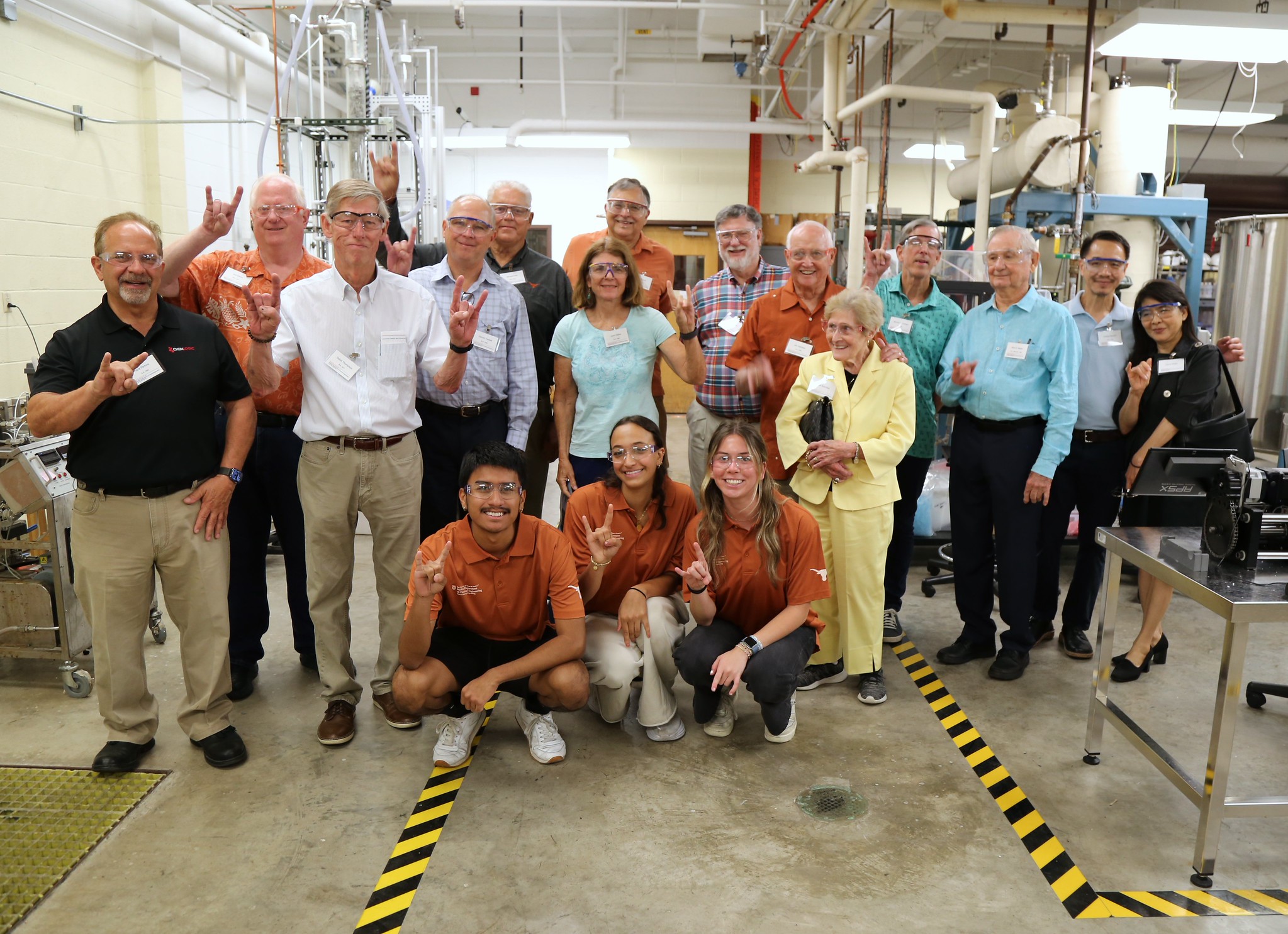 A group of Texas Engineering alumni smiling for photo during lab tour
