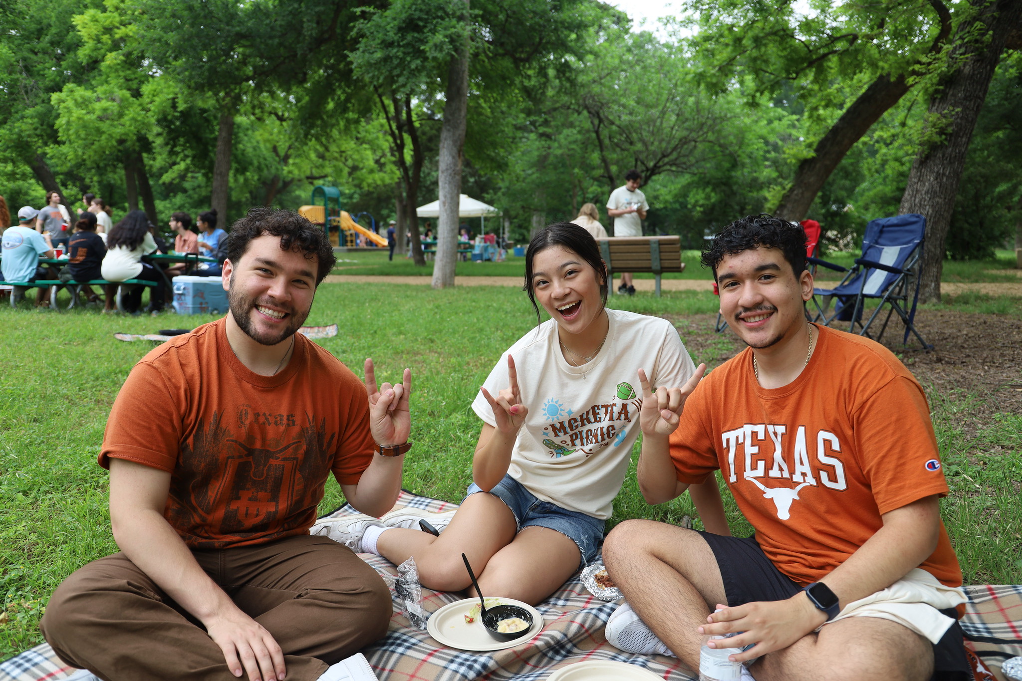 Texas ChE students smiling together on grassy area at McKetta Picnic