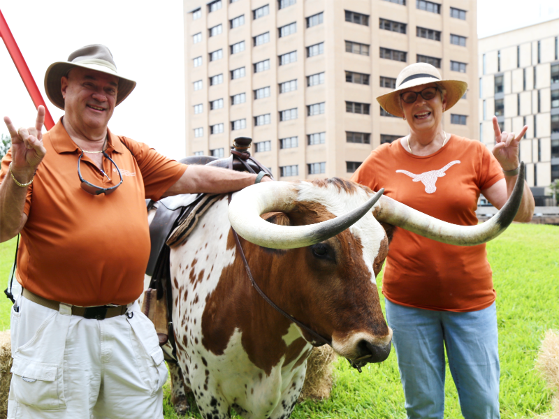 Texas ChE alumni smiling with Longhorn