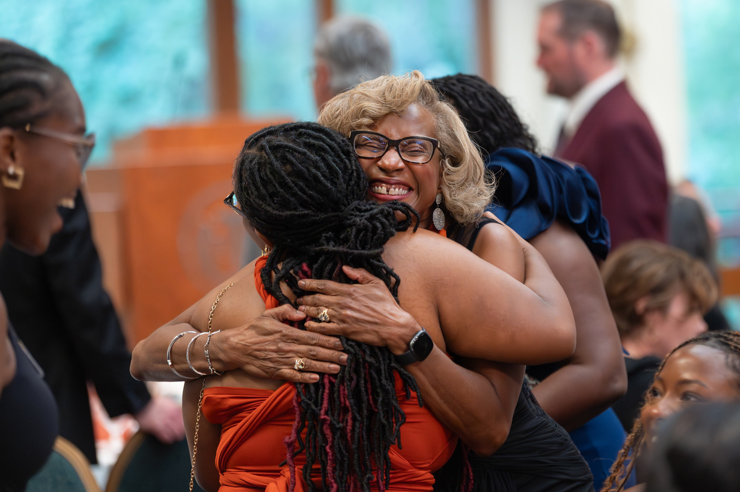 Texas chemical engineers hugging at gala event