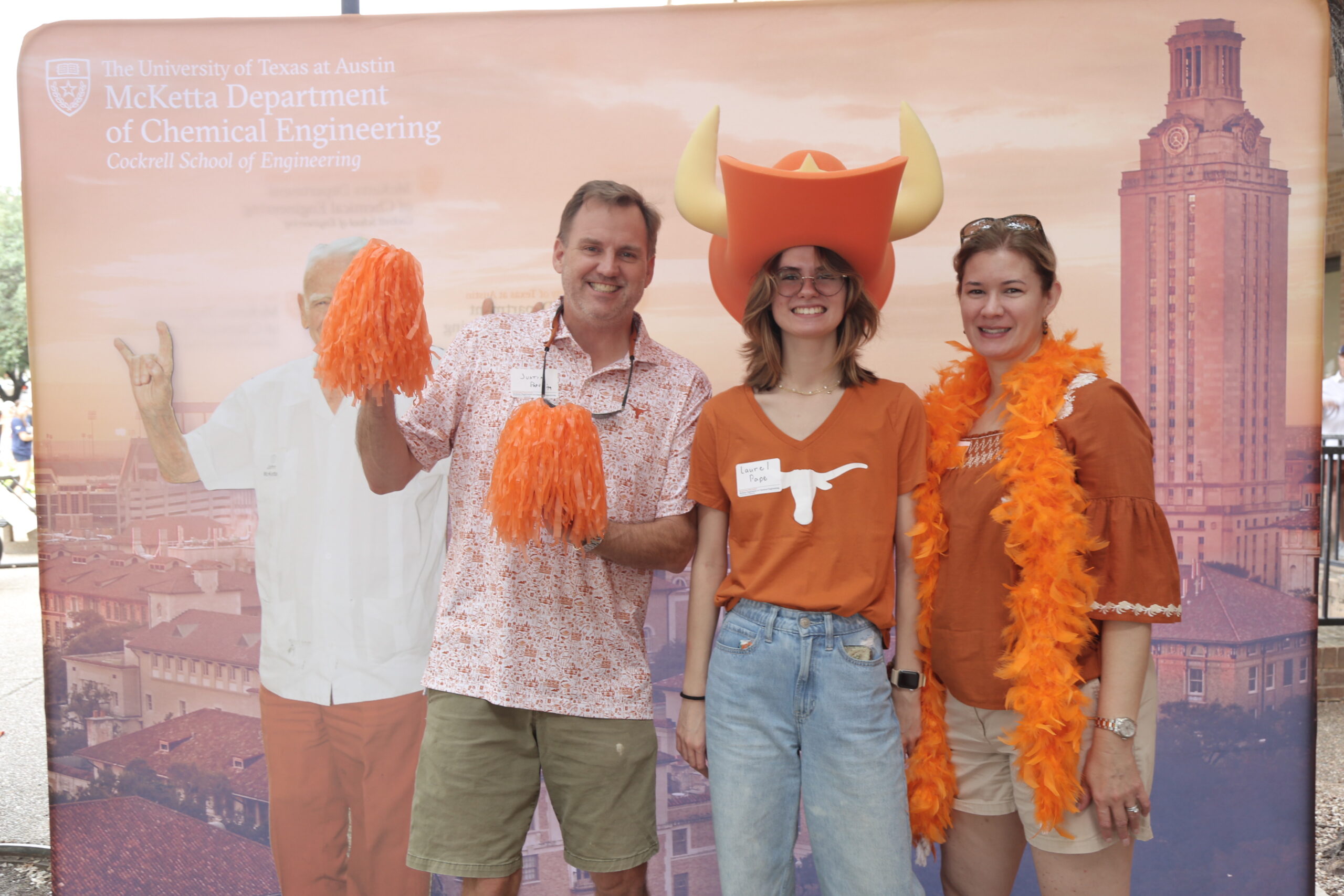 Texas ChE alumni and students smiling for photo in front of backdrop