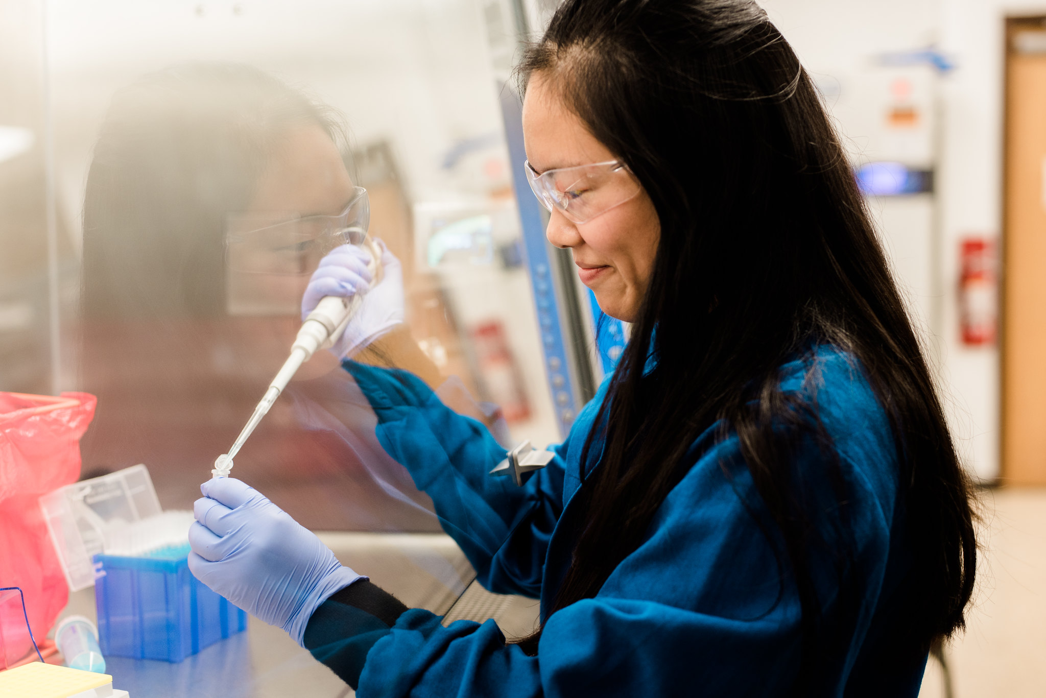 Graduate student conducting experiment in lab